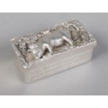 A small white metal lidded box. The lid decorated with a pig beneath an oak tree. The sides