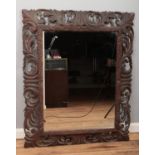 A large French oak mirror with carved and pierced border. 160cm x 95cm.