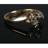 A 9ct Gold and two stone diamond crossover ring. Size LÂ½. Total weight: 2.2g.