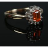 A 9ct Gold, fire opal and diamond cluster ring. Size R. Total weight: 2.9g