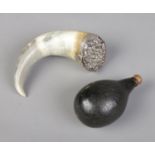 Two antique powder flasks. Includes horn example with white metal top and gourd example.