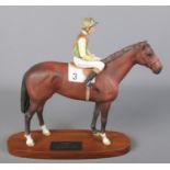 A Beswick figure group of racehorse Nijinsky and jockey Lester Piggot. Raised on wooden plinth base.