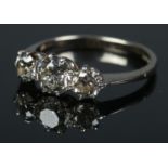 An 18ct white gold three stone diamond ring. Size K. 2.64g.