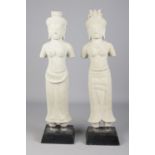 After antiquity, a pair of Khmer style carved stone sculptures, raised on wood plinths. Heights 62cm