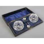 A cased set of silver rimmed salts and spoons. Assayed London 1914 by Henry Perkins & Son.