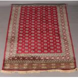 A red ground cashmere Bokhara carpet. 200cm x 300cm.