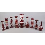 A quantity of ruby and opaque glassware, mainly vases, including one floral example.