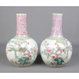 A large pair of Chinese Famille Rose bottle vases. Decorated with peacocks and flowers. Jingdezhen