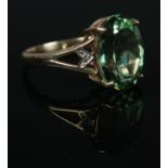 A 9ct Gold, large green stone and diamond accent dress ring. Size P. Total weight: 3.7g.