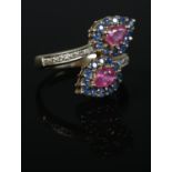 A 9ct Gold sapphire, ruby and diamond crossover dress ring. Size NÂ½. Total weight: 4.7g