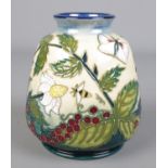A Moorcroft pottery vase decorated in the Fruit Garden pattern designed by Nicola Slaney. Height
