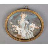 A 19th century gilt framed painted ivory miniature, portrait of a flower girl. Bearing Latin excerpt