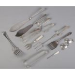 A quantity of mostly silver plated flatware. Including fish knives, sugar tongs, mother of pearl