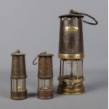 A small Protector Lamp & Lighting Company miners lamp along with two other stamped 1292 and Sir