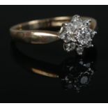 A 9ct Gold diamond cluster ring. Size N. Total weight: 3.1g Central stone 1/8ct.