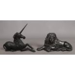 A pair of cast iron models of a lion and unicorn. Possibly formerly boot scrapes or fireside