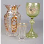 Three pieces of Bohemian glass. Includes Moser beaker with gilt rim, large uranium glass goblet