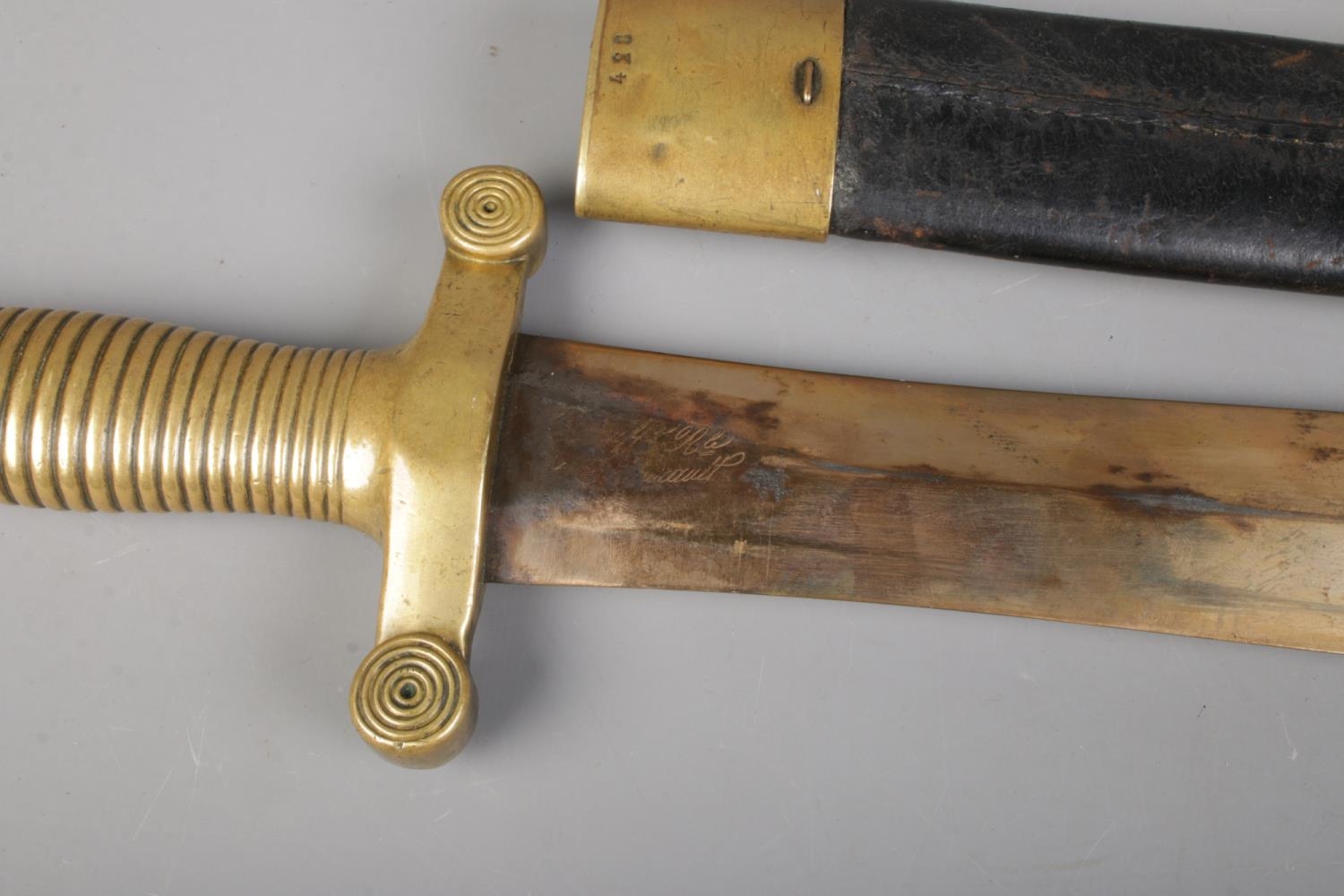 A French 1831 model short sword with brass and leather scabbard. Bearing anchor mark to cross guard, - Image 3 of 4