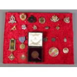 A display tray of badges and medals, to include Army and Royal Engineers examples.