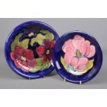 Two Moorcroft pottery dishes. The larger decorated in the Clematis design, 22cm diameter, the