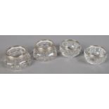 Two pairs of cut glass silver rimmed salts.