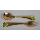 A silver gilt fork and spoon set by Georg Jensen, with matching enamel floral decoration to each