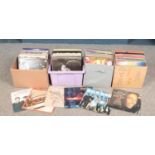 Four boxes of LP records. Includes The Beatles, Bob Marley, Blondie, Meat Loaf etc.