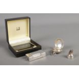 A silver plated Dunhill lighter in box, together with a silver sovereign holder and tooth fairy