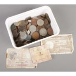 A box of British and world coins and bank notes. Including George V florin and half crown, Victorian