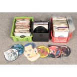 Two boxes and a carry case of single records. Mostly pop, including picture discs.