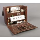 An antique doctors case, with contents. To include bottles, name plaque and medical instruments