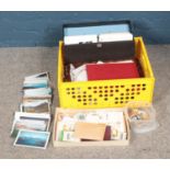 A box of assorted stamps, postcards and photographs including international examples.