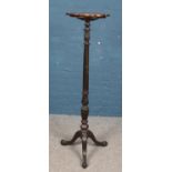 A Victorian tall standing carved mahogany jardiniere stand. On tripod base with ball and claw