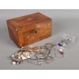 A small hinged walnut jewellery box with contents of silver and white metal jewellery and oddments.