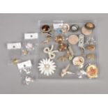 A collection of costume jewellery brooches and pin badges.