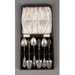 A cased set of James Linton silver arts and crafts coffee spoons depicting various Australian flora.