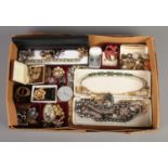 A tray of costume jewellery. To include assorted necklaces, brooches, pill boxes and clip on