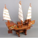 A wooden model of a ship with oriental decoration. (60cm x 60cm)
