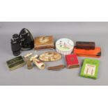 A quantity of collectables to include corkscrews, vintage tins, binoculars, etc.