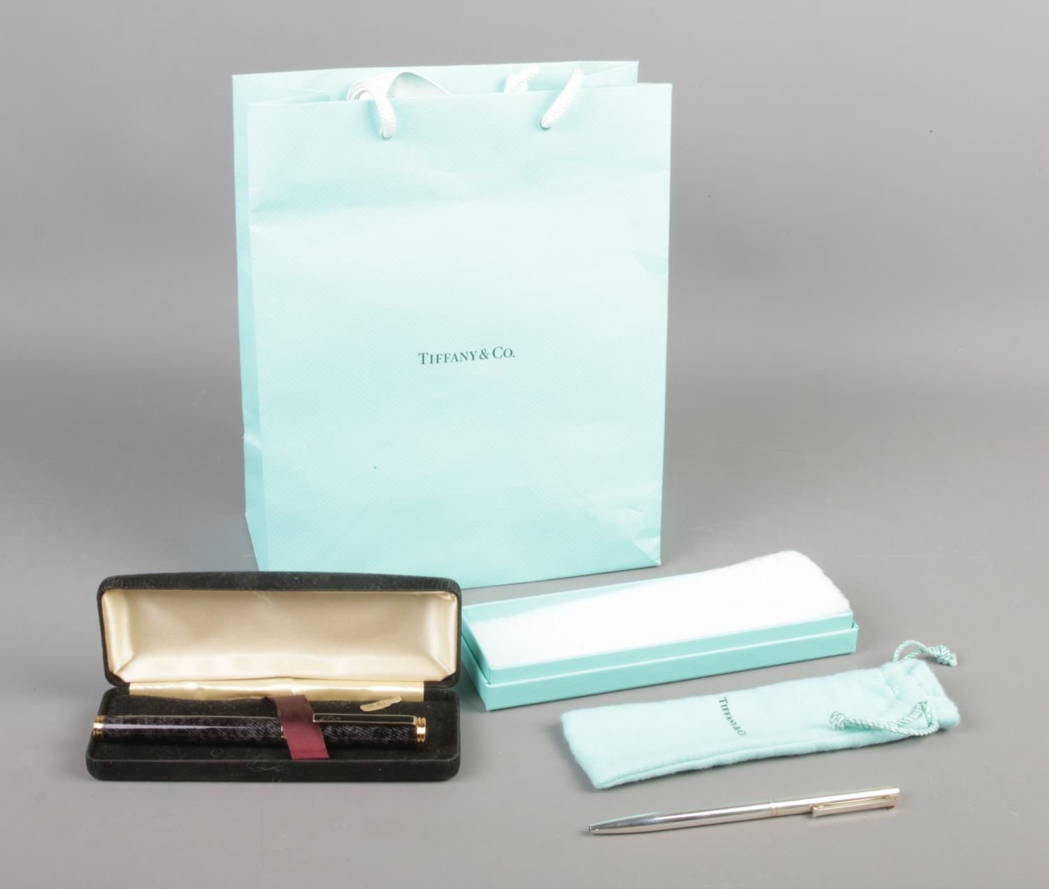 A Tiffany silver ballpoint pen, in drawstring bag and box, together with a cased L'Plume fountain