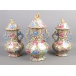 A Chinese garniture set comprising of three lidded vases. Baring Jaiqing character marks. Tallest