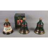 Three sealed and full Bell's Whiskey Christmas bell decanters including 1990 and 2 x 1992.