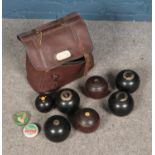 A bag of vintage lawn bowls to include several Hemselite examples. Seven total.