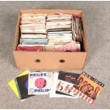 A box of single records. Includes The Beach Boys, Elvis Presley, Bon Jovi, UB40 etc.