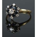 An 18ct diamond and sapphire ring. Size O, 3.3g.