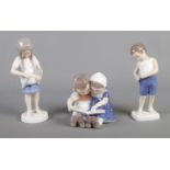 Three Bing and Grondahl ceramic figure groups; Boy 1759, Girl with Kitten 1779 and children