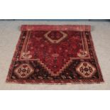 A wool rug featuring woodland floral design and edge fringe. 233cm x 148cm.