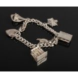 A silver and white metal charm bracelet, on hallmarked silver chain. Contains six charms including