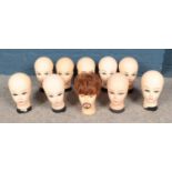 A box of vintage mannequin display heads.