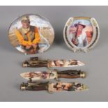 A quantity of John Wayne memorabilia to include Bradford Exchange knives and cabinet plates.
